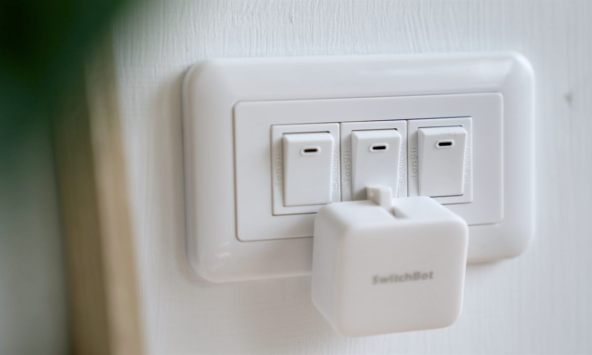 SwitchBot Bot installed on a regular wall light switch