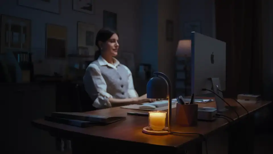 Candle Warmer Lamp adding warm scent and light beside a work desk